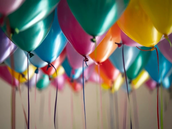 Colourful unicorn-themed birthday party with rainbow balloon arch