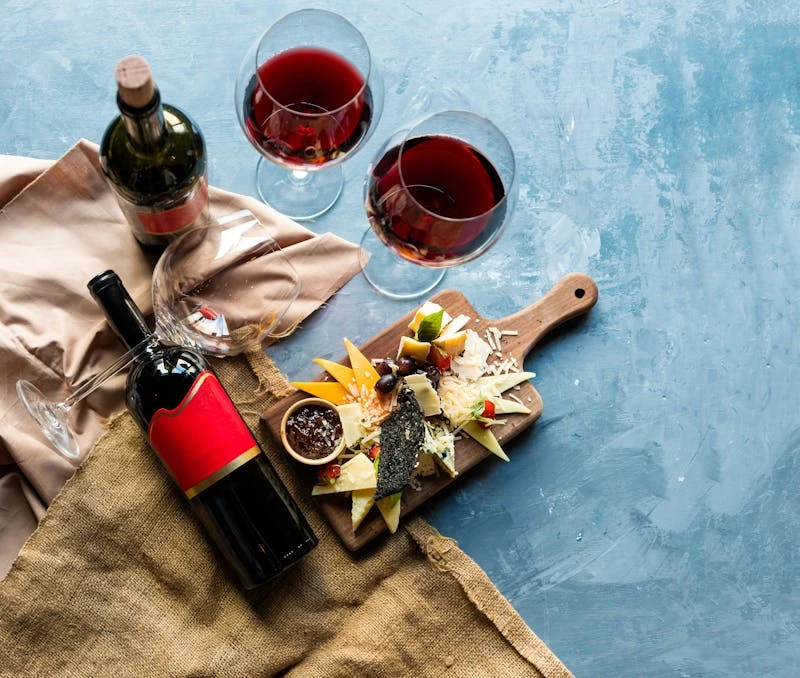 Deep red wine poured from a bottle
