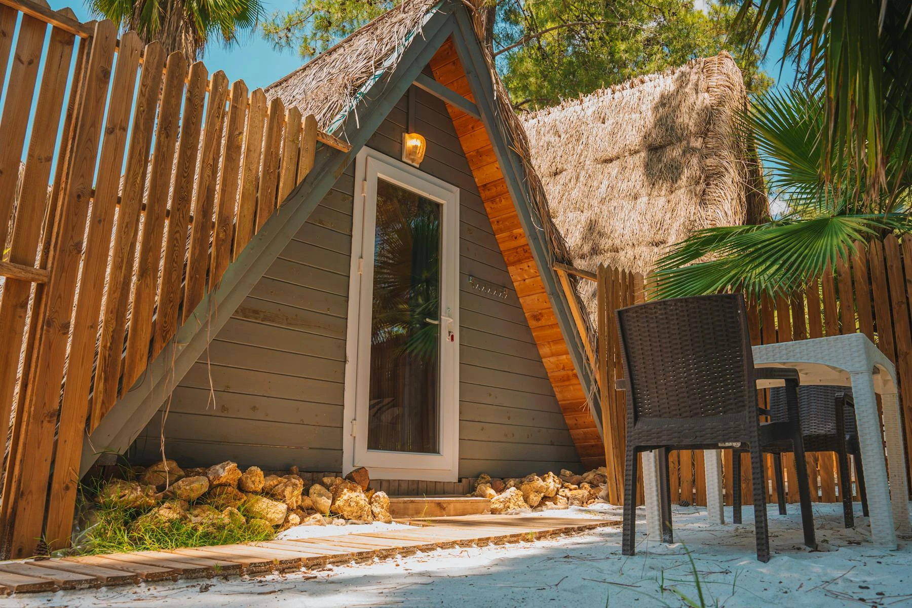 A thatched A-frame bungalow on the estate grounds