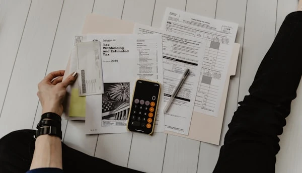 Person reviewing budget documents at a desk