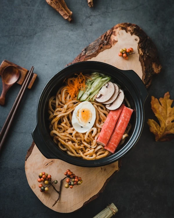 Steaming bowls of ramen in a dark Japanese kitchen