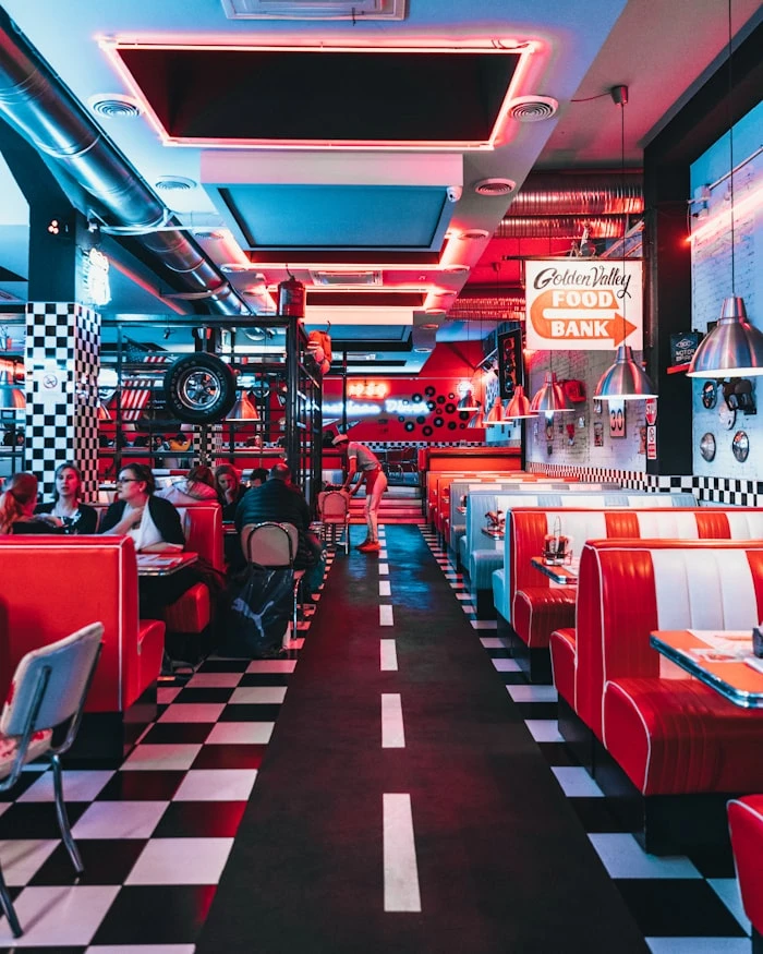 Japanese ramen shop interior — warm light, dark wood, minimal
