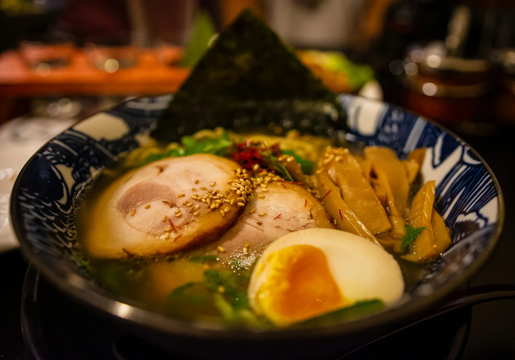 A cook's hands at work at a Japanese noodle bar — close-up, black and white