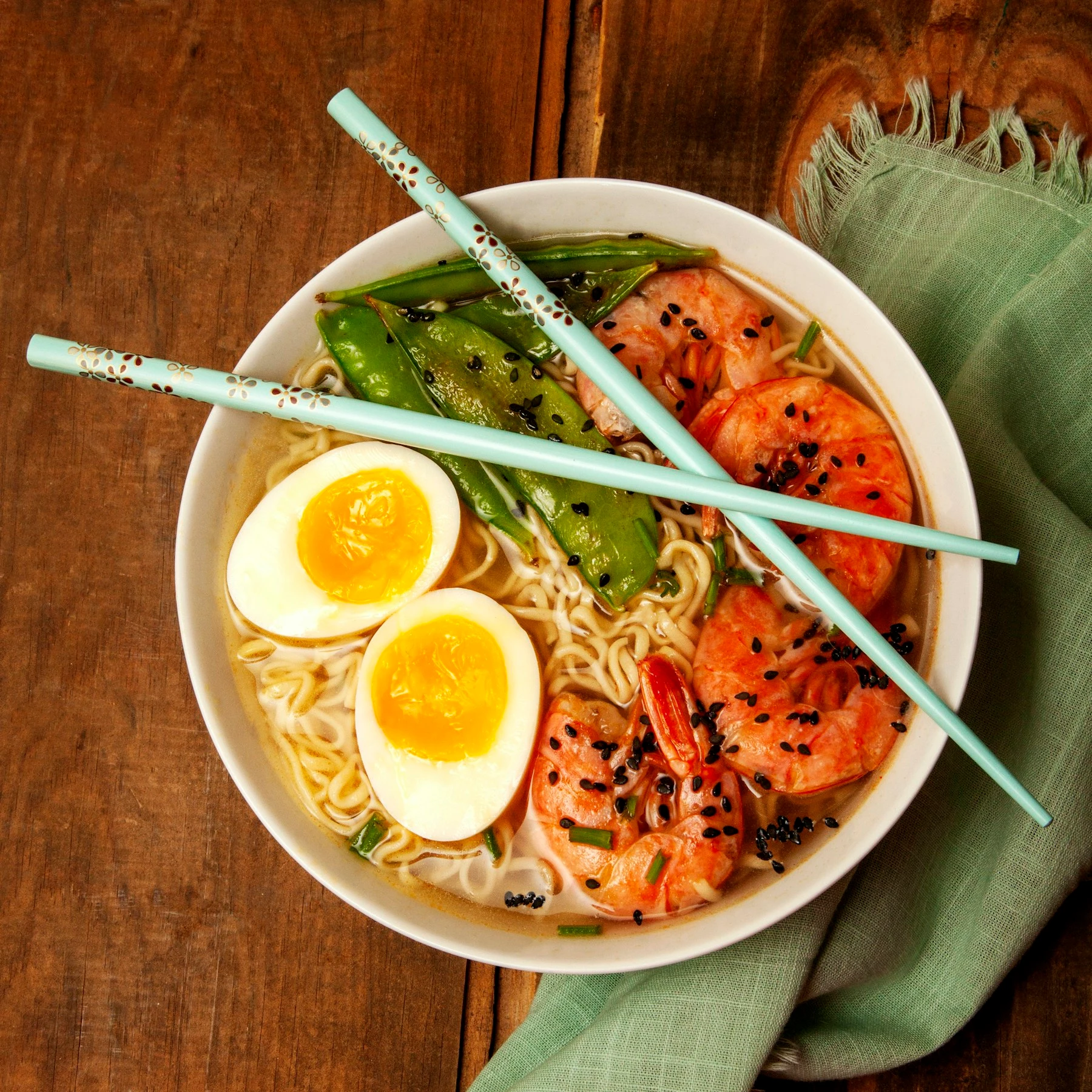 Dark atmospheric view of a ramen bowl from above
