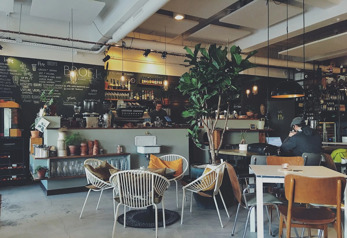 Bright café interior with marble tables and rattan chairs