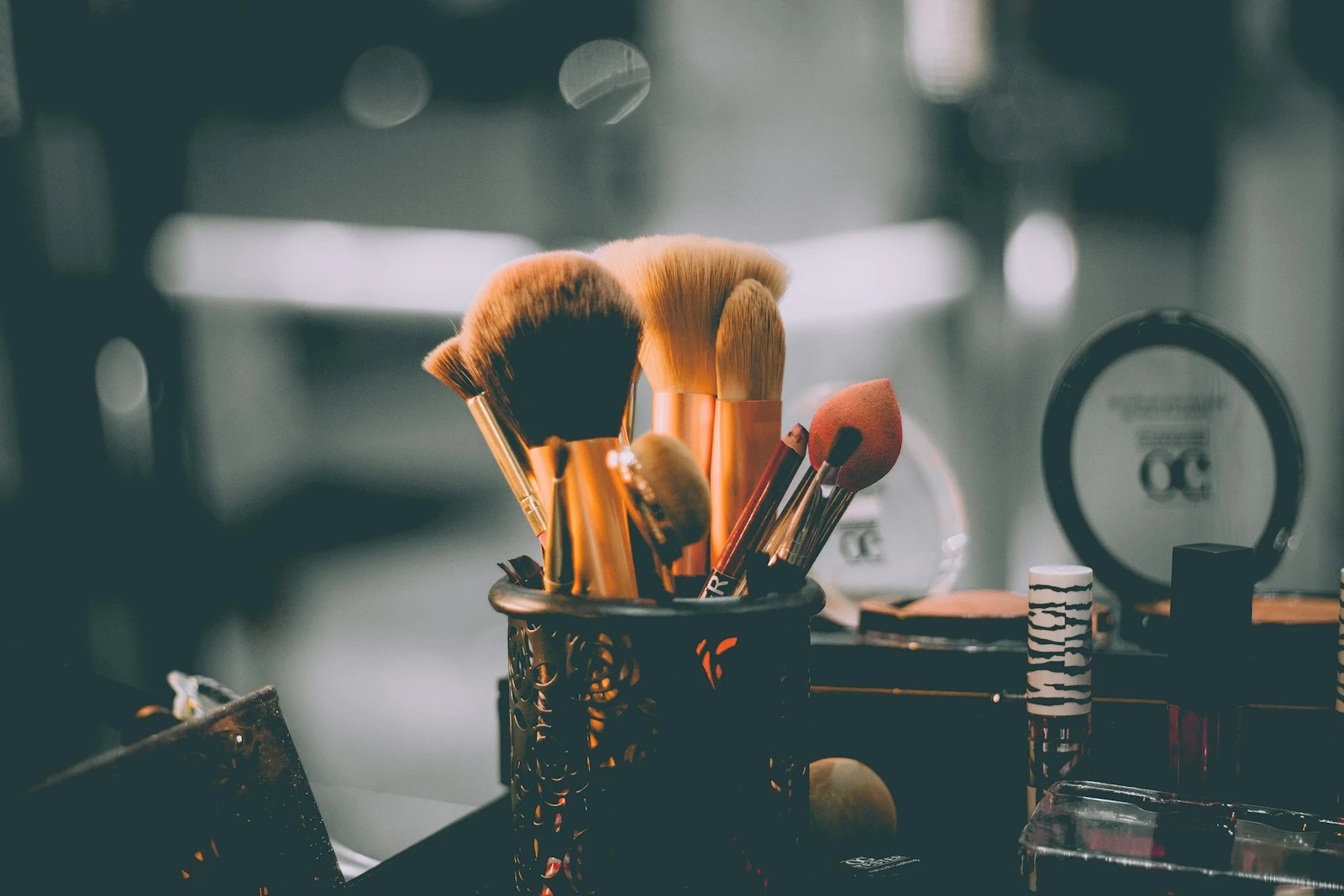 Stylist's hands applying toner to hair strands