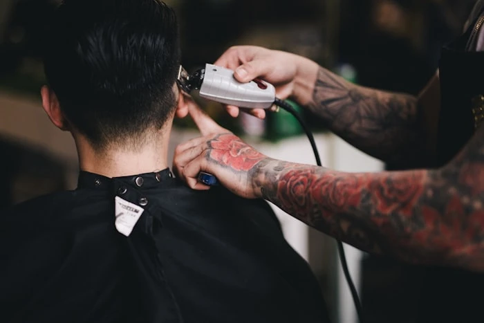Barber styling a client with precision and care